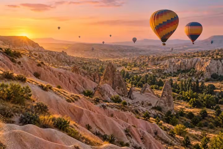 Sunrise hot air balloons over the pink ridges of Cappadocia’s Rose Valley