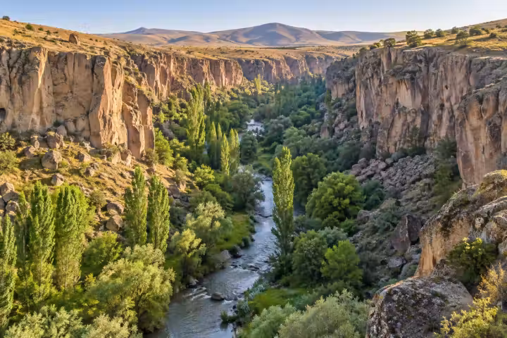 Melendiz River and green trees between the rock walls of Ihlara Valley