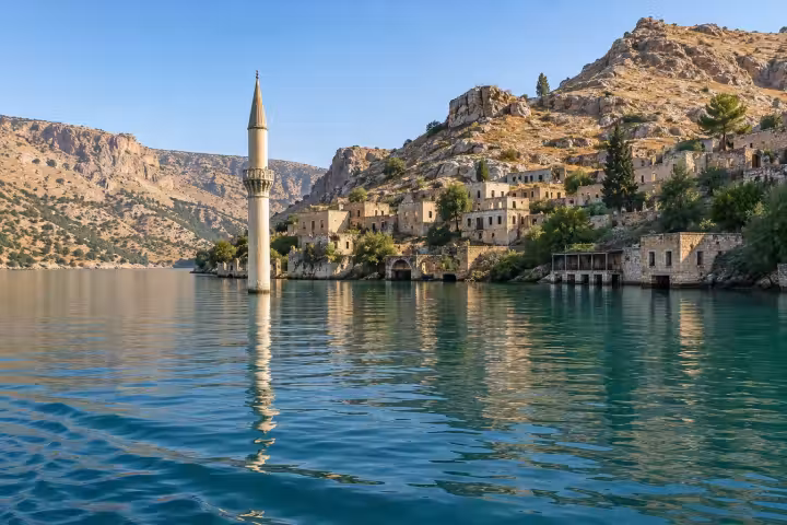 Partly submerged minaret and stone village beside the Euphrates reservoir near Halfeti