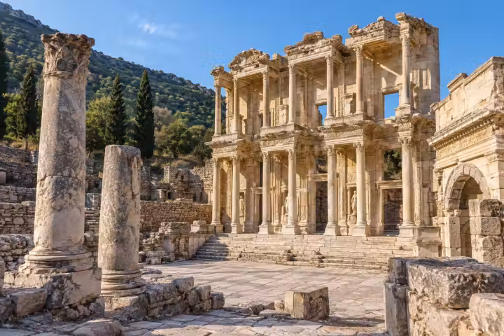 The Library of Celsus at Ephesus in warm morning light, with weathered columns beside its marble forecourt