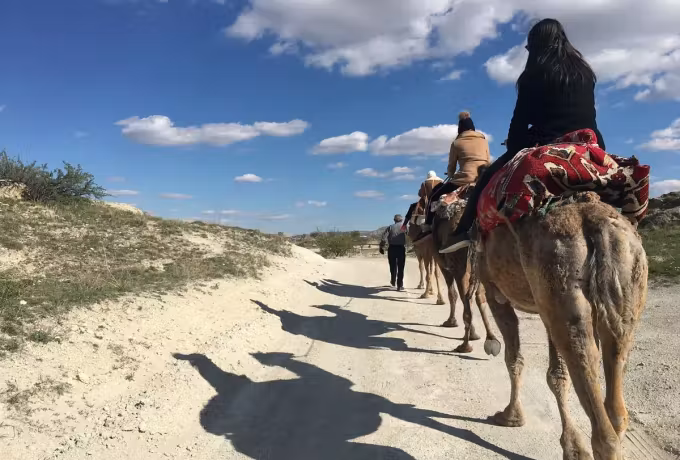 Looking forward from the saddle down a pale track that crosses open Cappadocia country