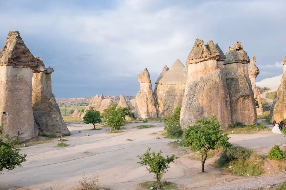 Capped stacks beside a deserted roadway in the gentle light following sunset, Cappadocia
