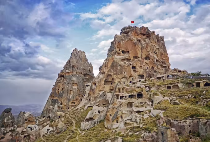 Weather massing over the outcrop with the national colours at its highest point, Cappadocia