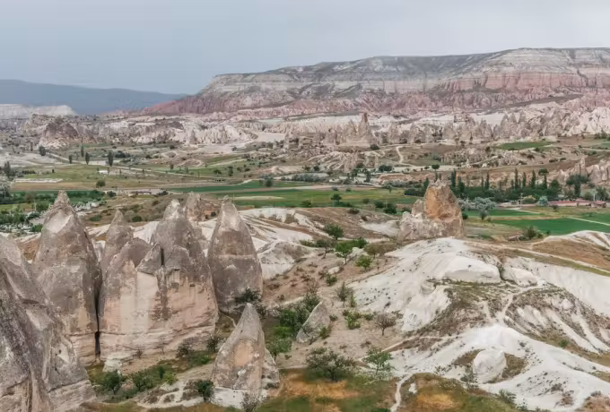 Worked fields lying between eroded stacks in the wide basin below Zelve