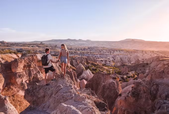 Two stopped at the lip where corrugated pink country falls steeply away, Cappadocia