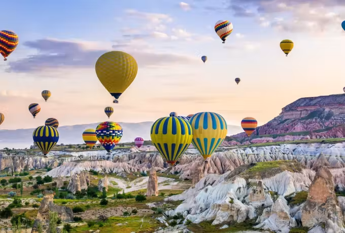Hot air balloons rising over a valley in Cappadocia