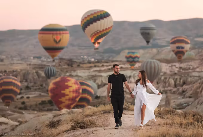 Trailing white skirt on a rough lane while fabric comes down on all sides, Cappadocia