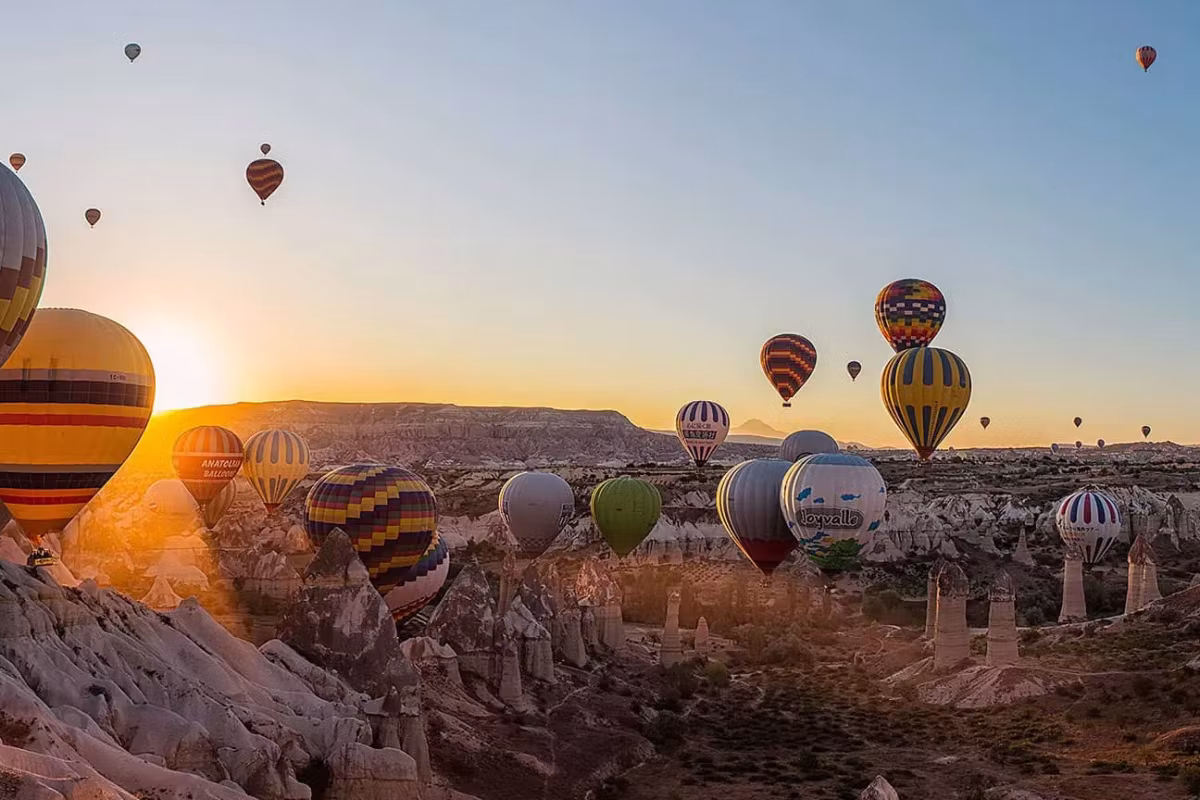 First rays finding fabric that has barely left the bowl of worn rock and brush, Cappadocia