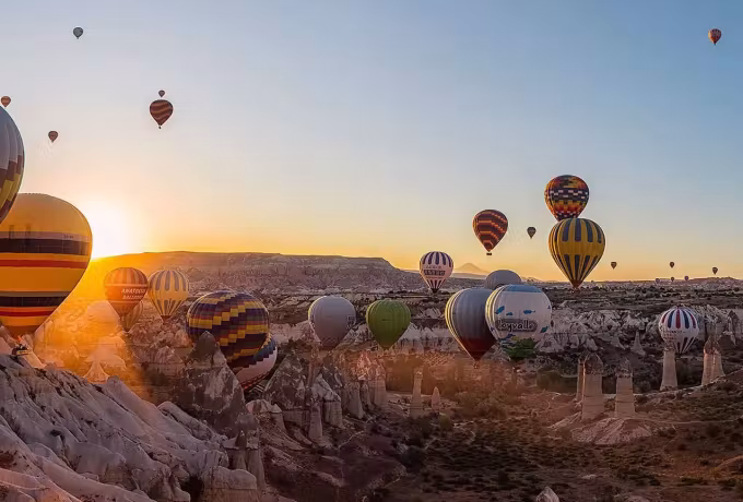 First rays finding fabric that has barely left the bowl of worn rock and brush, Cappadocia