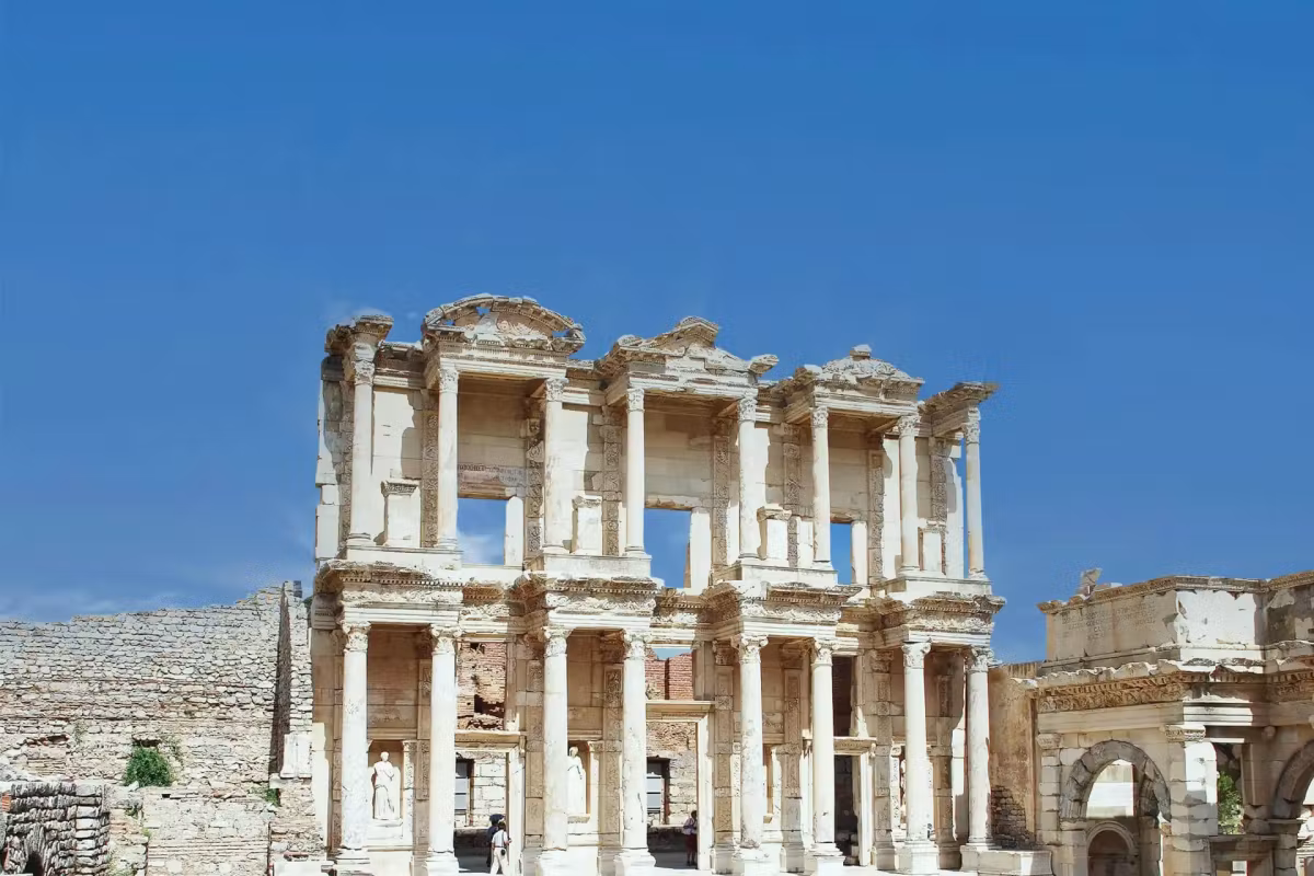 Nothing but empty blue behind the bleached two-tier elevation of the reading room at Ephesus