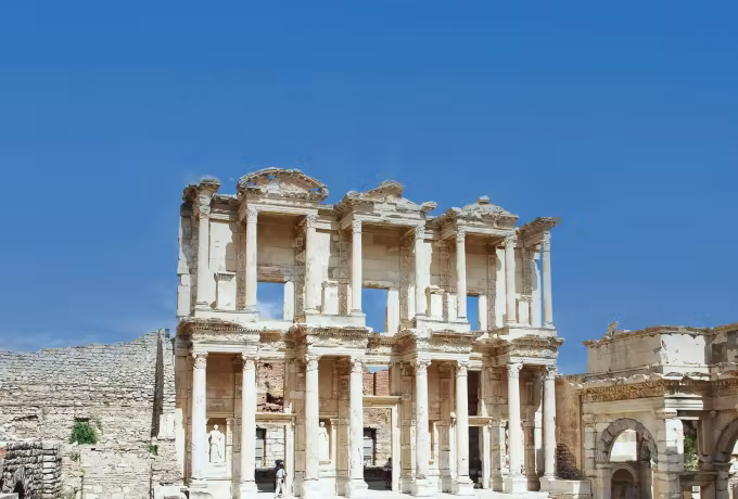 Nothing but empty blue behind the bleached two-tier elevation of the reading room at Ephesus