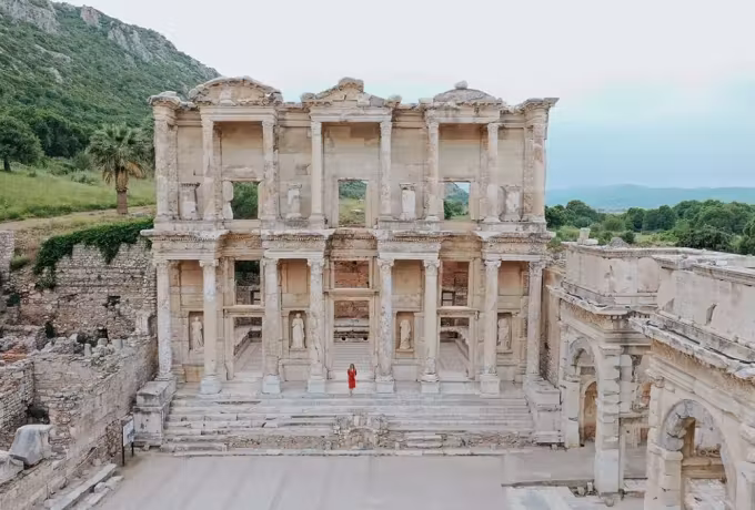 One figure in red placed centrally on the broad steps, the front rising evenly above, Ephesus