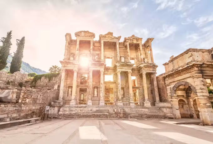Sun flaring past the corner of the Celsus front and starring across an empty marble court, Ephesus