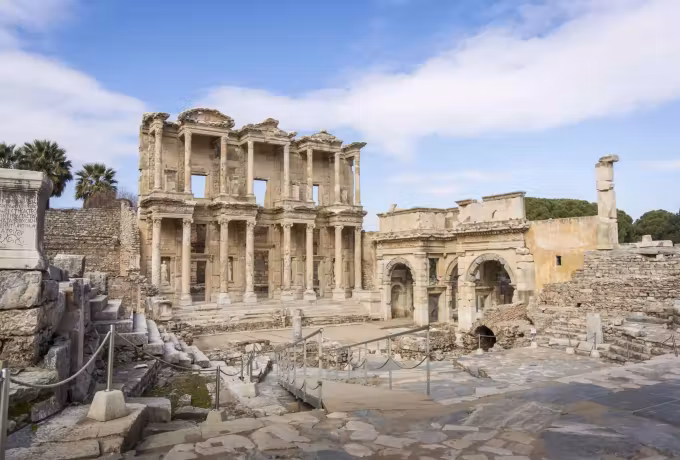 Crisp cold light on the Celsus front and its neighbouring gate, the court nearly bare, Ephesus
