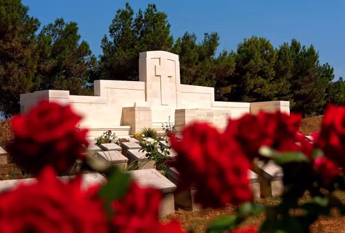 Roses and a stone memorial at a Gallipoli cemetery