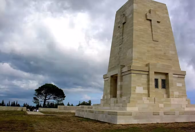 Heavy cloud behind the tall worked monument that closes the Lone Pine plot, Gallipoli