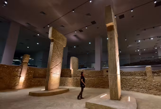 Head tipped back at a great upright cut with a snake in the museum's Gobeklitepe hall