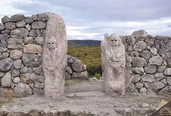 Autumn country seen between the two carved wardens of the King's Gate at Hattusa