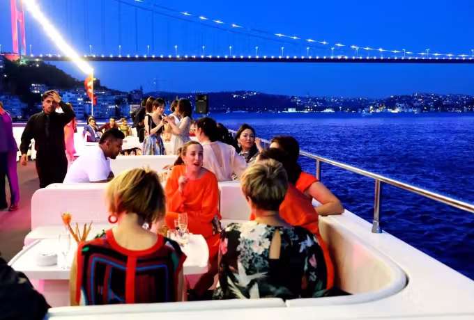 Dining out on the top deck as the lit span reaches across the night above the Bosphorus