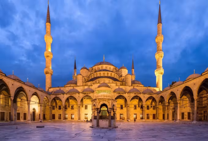 Illuminated courtyard of the Blue Mosque in Istanbul at dusk