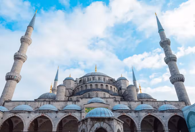Lower cupolas and arcading filling the frame with two towers going up into cloud, Istanbul