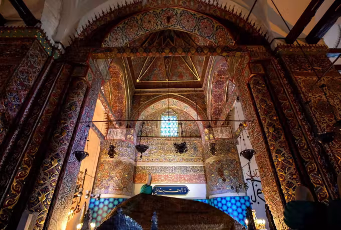 Painted ritual room at the Mevlana in Konya, gilt arabesque, lamps overhead and coloured glass