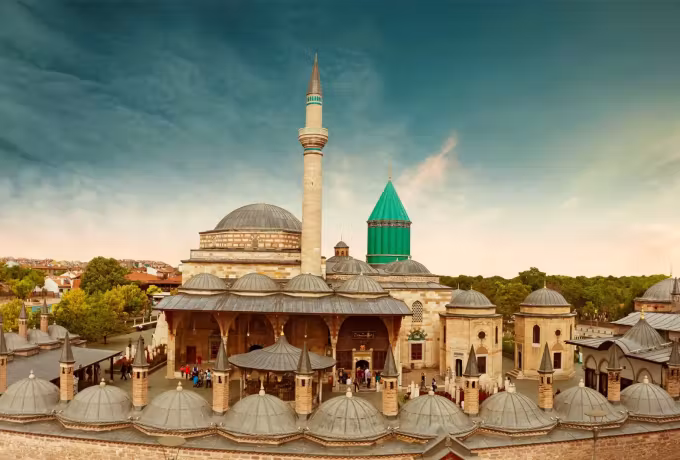 Ranks of small lead cupolas roofing the yard arcade at the Mevlana, tomb cone and shaft above
