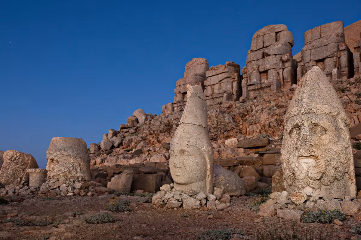 Pair of enormous faces resting where the enthroned figures above them have collapsed, Mount Nemrut