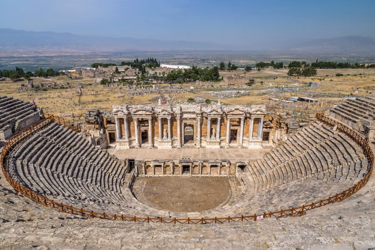 Curved stone seating and the decorated stage building of the theatre at Hierapolis