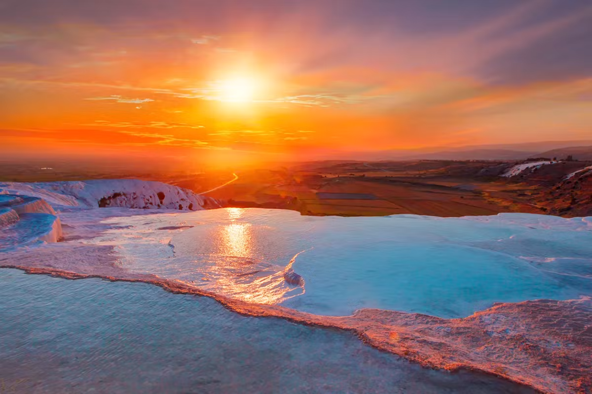 Sun resting on the edge of the world, its track laid over every shallow rim, Pamukkale