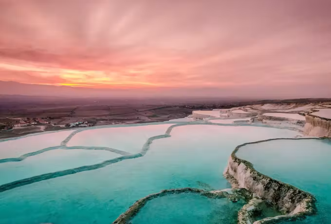 Water nearest the lens with a wide rose and mauve evening over the hazy plain, Pamukkale