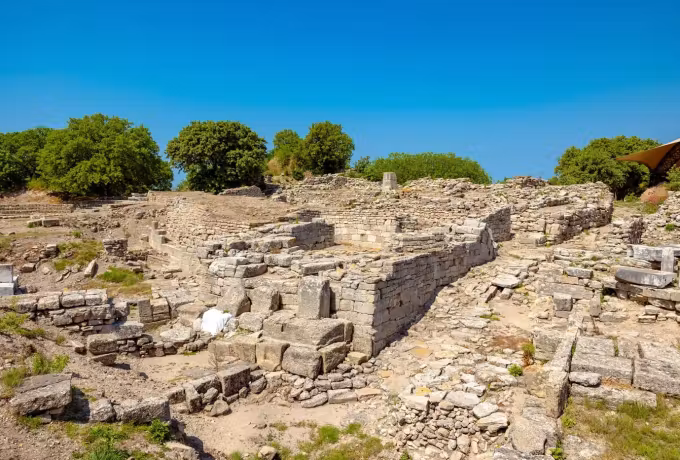 Broad look over crowded stone footings on the bleached tableland of the Troy site