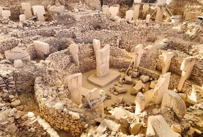 Looking down into the largest ring at Gobeklitepe, a dozen low stones around the tall pair