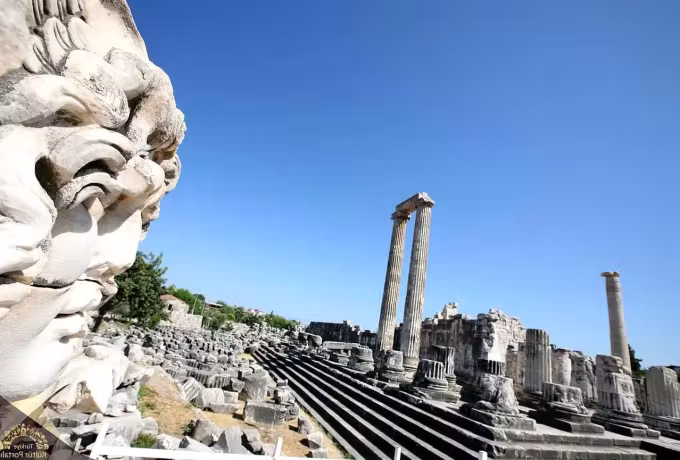 Gorgon head close to the lens, the tiered base and surviving shafts of Didyma running back