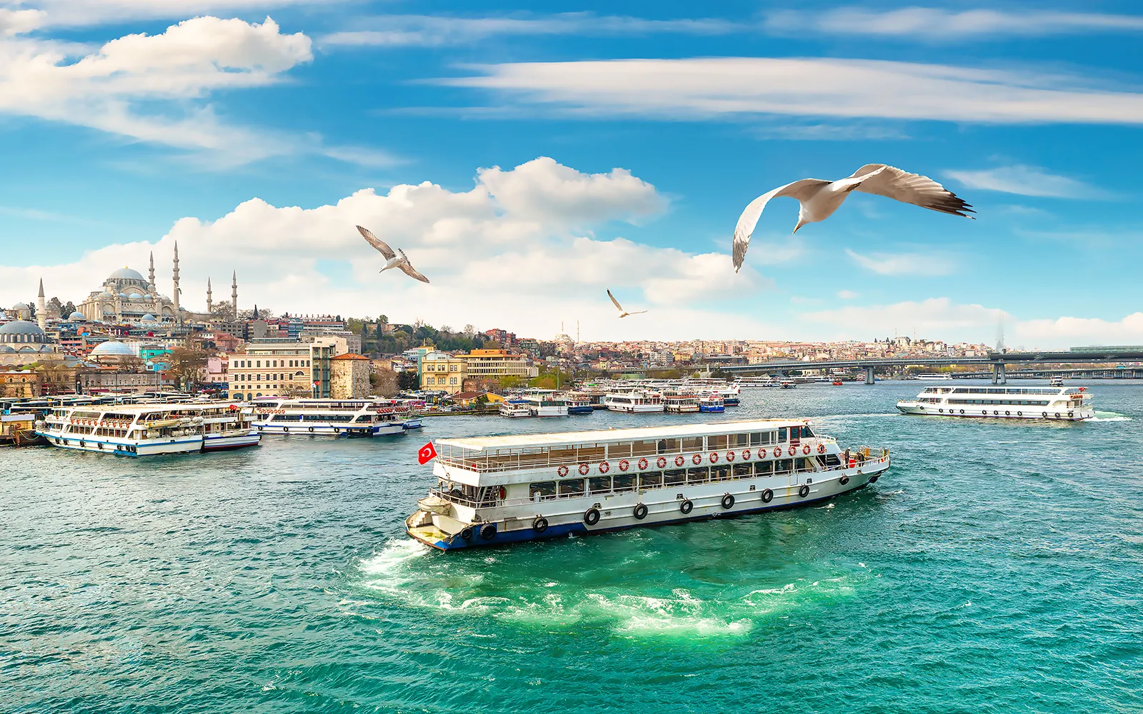 Passenger boats on the Golden Horn near Eminönü, with the waterfront and Galata Bridge behind them