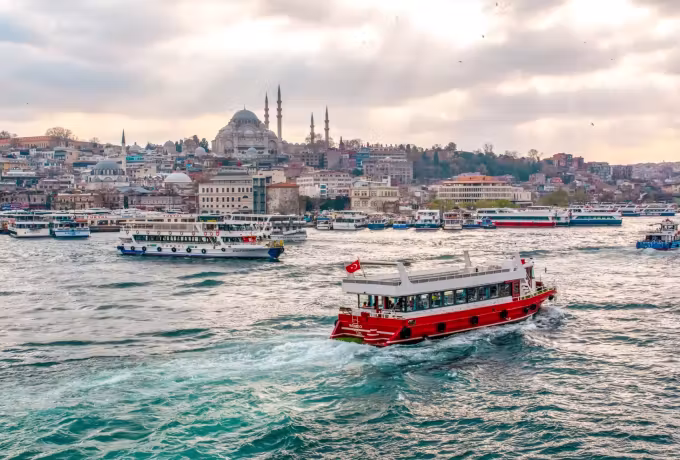 Ferry swinging round off Eminonu with the great hill mosque of Istanbul standing behind