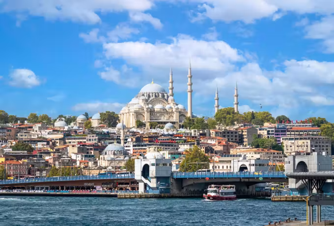 Galata crossing seen from the water, a domed mosque on the slope above the Golden Horn