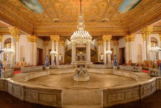 Marble basin at the centre of a great hall beneath gilt coffering and a cut-glass lustre, Istanbul