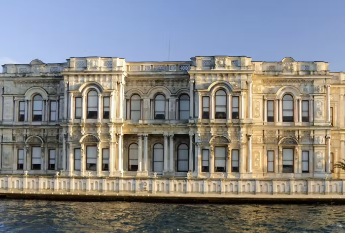 Warm light on the moulded openings and flat columns of the shore palace elevation, Istanbul
