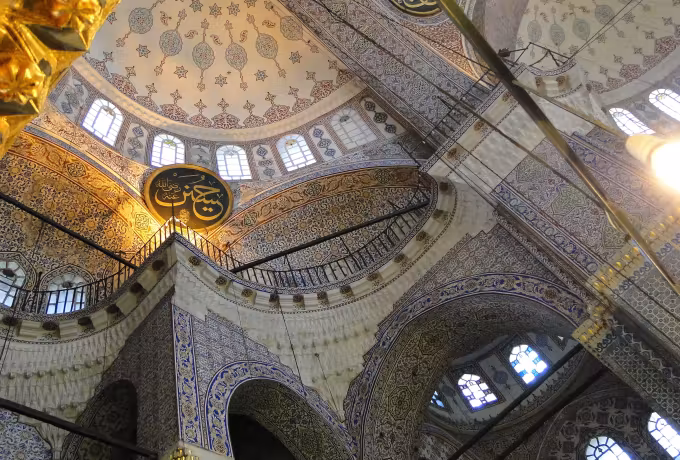 Decorated soffits and tiled fields curving above openings glazed in coloured panes, Istanbul