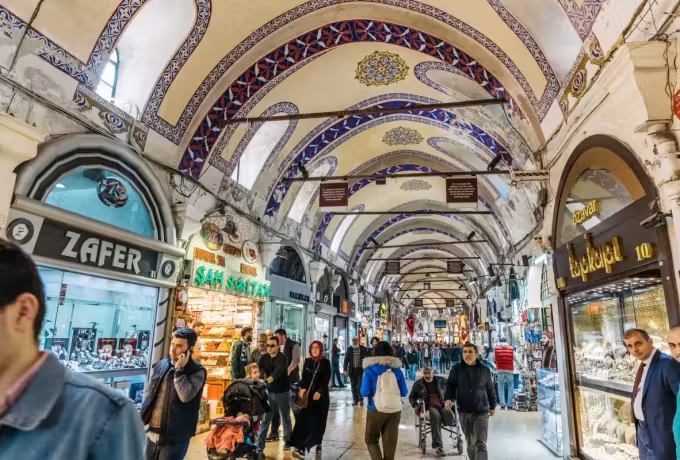 Ottoman pattern in blue and gilt overhead while customers work down the passage