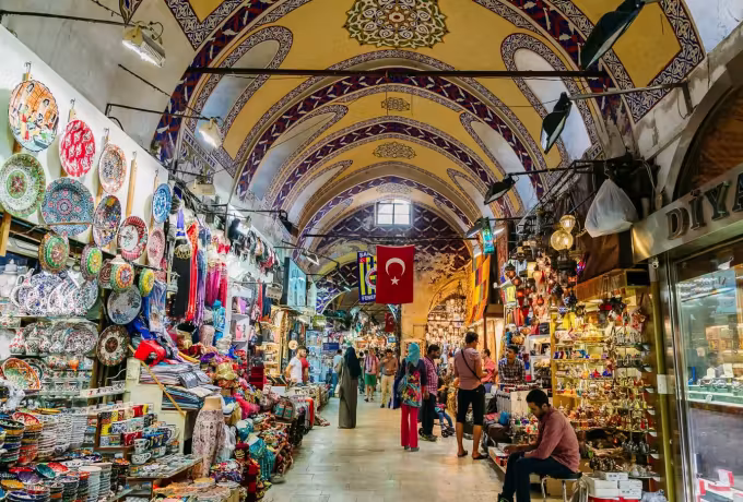 Dishes, lamps and trinkets crowding both flanks of a barrel-roofed market lane, Istanbul
