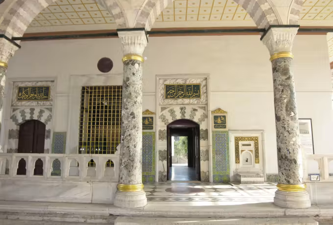 Veined marble uprights carrying portico arches in front of a richly worked entry, Istanbul