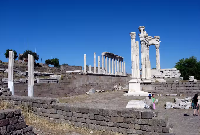 Split gable and upright shafts on the Pergamon terrace set hard against clear blue