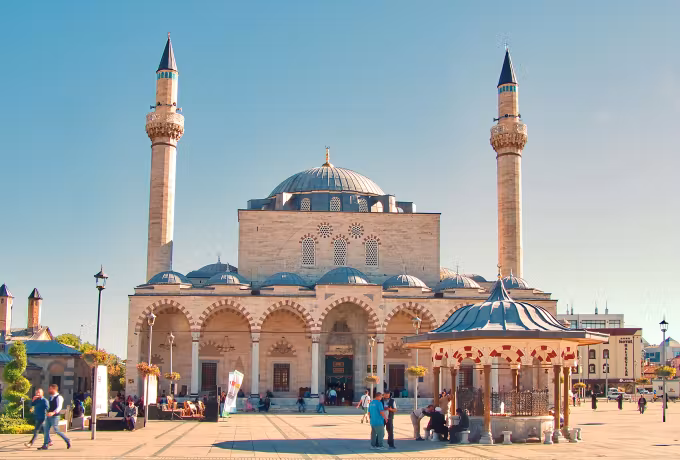 Two shafts and lead roofing at Selimiye above a crowded Konya plaza and its arcaded front