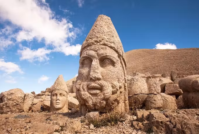 Enormous diadem-wearing faces set out on the exposed summit platform in Adiyaman