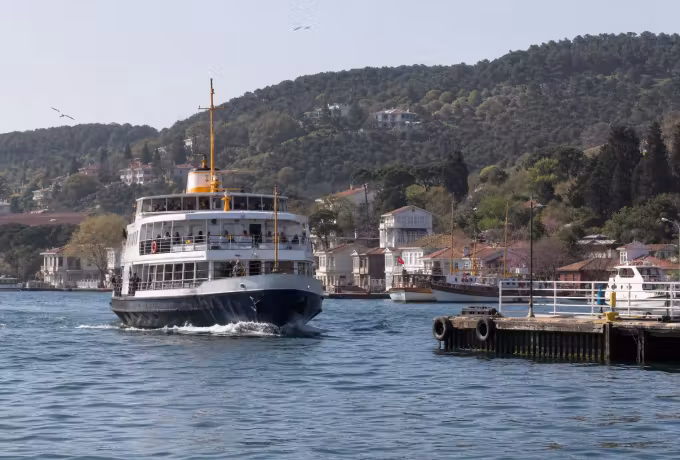 Ferry coming in to the quay at Heybeliada below the wooded hills of the island