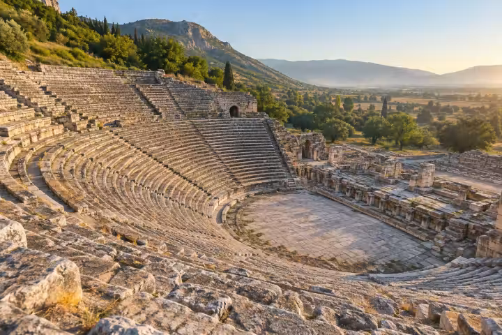 Curved stone seats of the Great Theatre at Ephesus in warm morning light