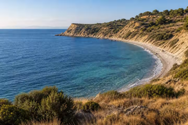 Clear Aegean water beside a pebble cove and coastal hills on the Gallipoli peninsula