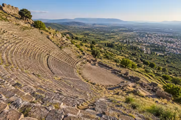 Steep ancient theatre seating above the green valley and town of Bergama